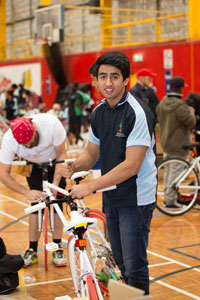 A Happiness Cycle participant builds his bike